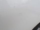 a close up of a white car with a hole in the side