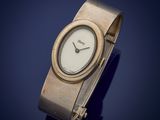 a close up of a wrist watch on a blue surface