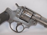 an old gun is on a white surface with a white background
