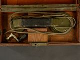 a wooden box with a phone in it on a table