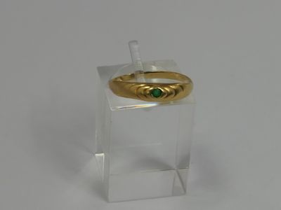 an image of a gold ring with a green stone on it