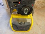 a small machine that is sitting on top of a yellow stand