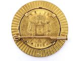 a gold coin with a bar in the middle of it