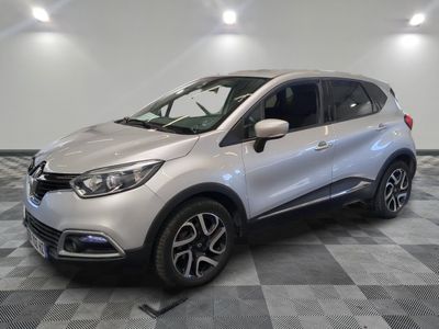 a silver car is parked in a room with a checkered floor