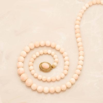 a close up of a necklace and a bracelet on a table