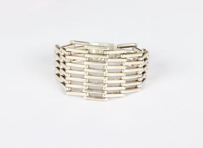 a close up of a silver ring on a white surface