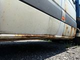 a close up view of a truck with rust on the side of it