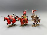 four figurines of knights on horseback with flags and shields