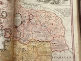 an open book with a map on it sitting on a table