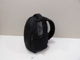 a black backpack that is sitting on a white table