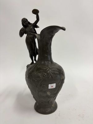 un vase noir surmonté d'une statue