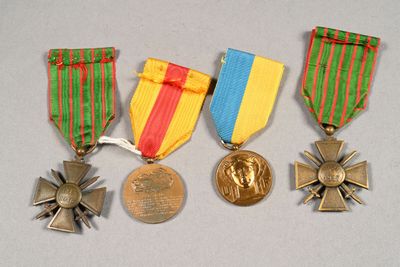 three medals and a medal are sitting on a table