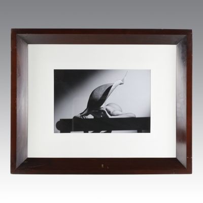 a black and white photo of a person laying on a bench