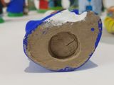a blue and brown object on a white table