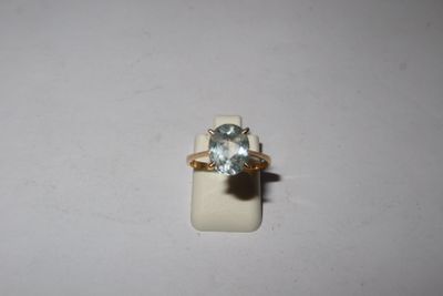 a close up of a ring with a blue topaz stone on it