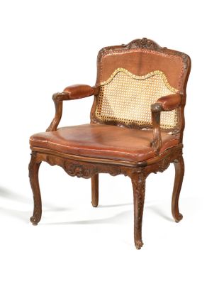 chair made of wood and leather with cane back and arms
