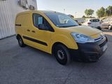 a yellow van parked in a parking lot next to a building