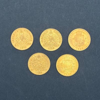quatre pièces d'or posées sur une surface bleue