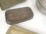 a small metal tin with a small metal container on it