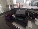 a computer sitting on top of a desk next to a window