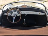 a brown cloth on the seat of a convertible car