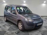 a small grey van that is parked on a checkered floor