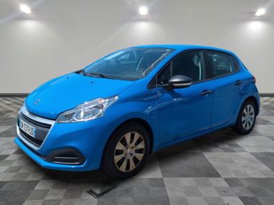 a blue car parked in a garage with a checkered floor
