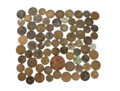 a close up of a pile of coins on a white surface