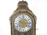 a gold clock with blue and white roman numerals on it
