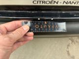 a hand that is holding a sticker that says citroen - naht