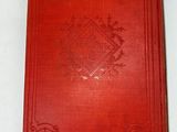 a red book sitting on top of a white table
