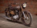 a old motorcycle that is parked in a garage