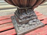 a large metal bowl sitting on a wooden pallet