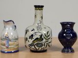 three vases sitting on a table next to each other