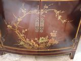 a brown cabinet with flowers and birds painted on it