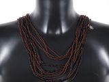 a close up of a mannequin with multiple strands of beads