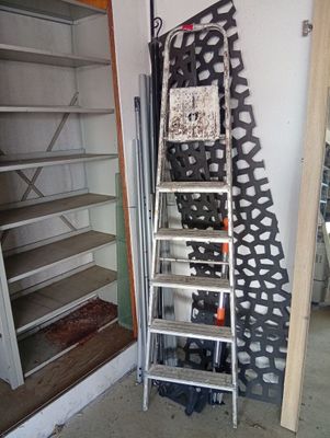a ladder leaning against a wall in a garage