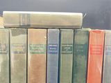 several books are stacked on top of each other on a table