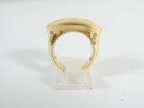 a close up of a gold ring with diamonds on a white surface