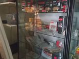 a glass display case filled with food inside of a store