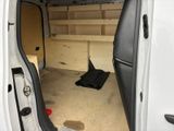 a white van with the door open and a black bag in the back