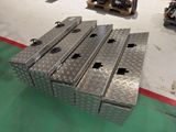 four metal boxes stacked on top of each other in a warehouse