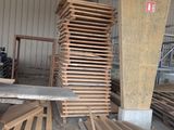 many pieces of wood stacked on top of each other in a warehouse