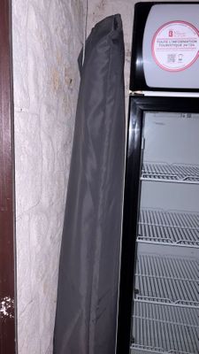 an open refrigerator with a black cover next to it