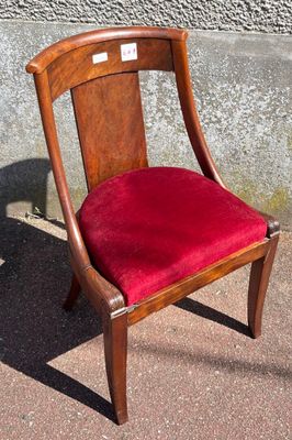 a red chair that is sitting on the sidewalk