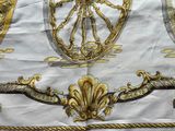 a white and gold table cloth with a design on it