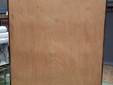 a large piece of plywood on a dolly in a room