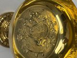 a gold plate with a gold seal on it