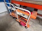 a cart with a table and a chair in the garage