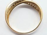 a close up of a gold ring on a white surface
